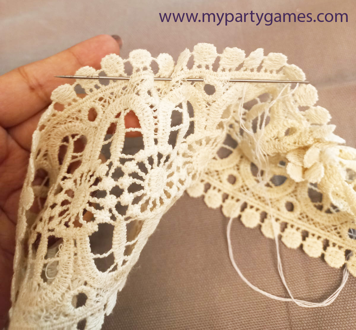 Create gathers in the piece of lace with needle and thread