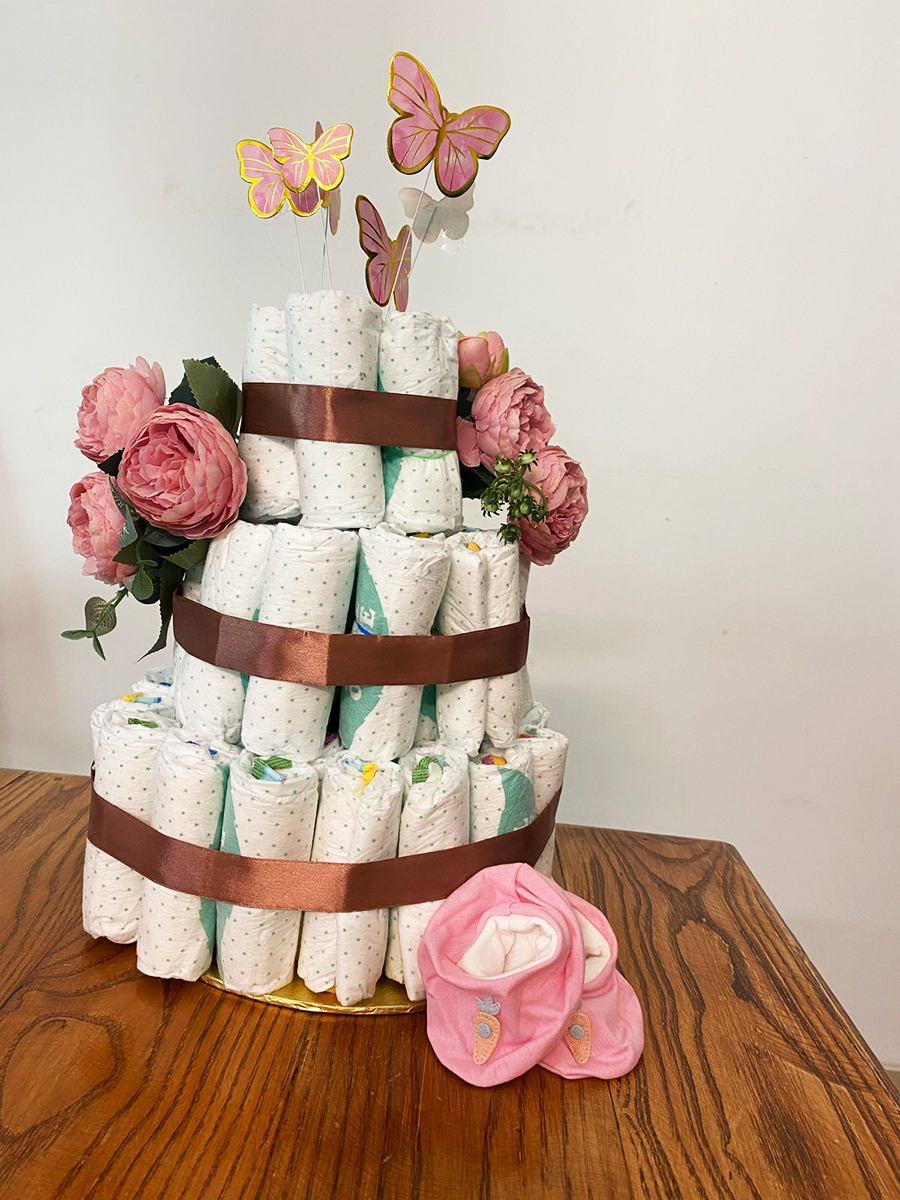 Diaper cake decoration with butterflies and flowers 